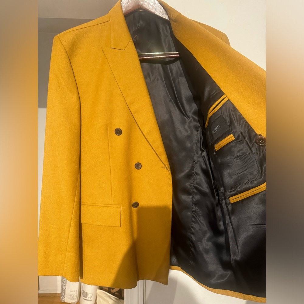 This is a mustard color men blazer.